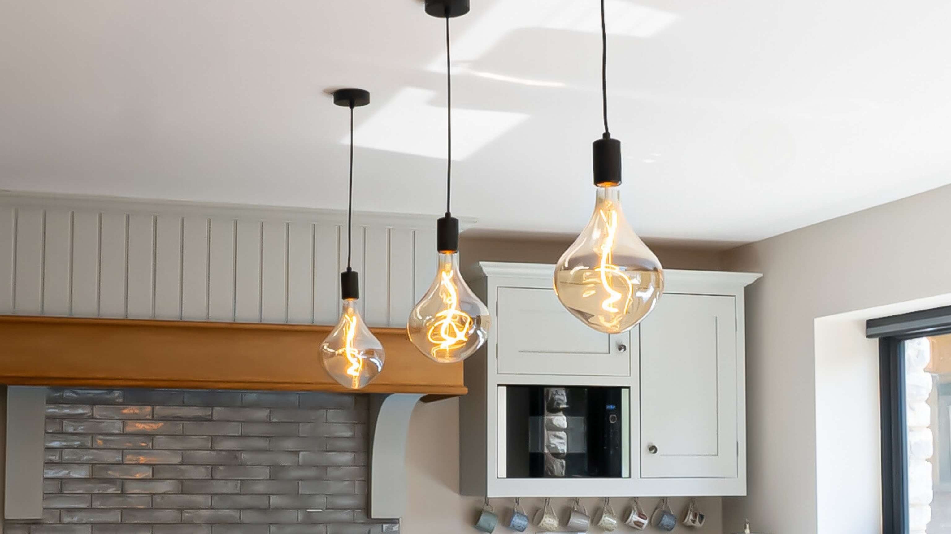 Exposed bulb pendants over a country style kitchen
