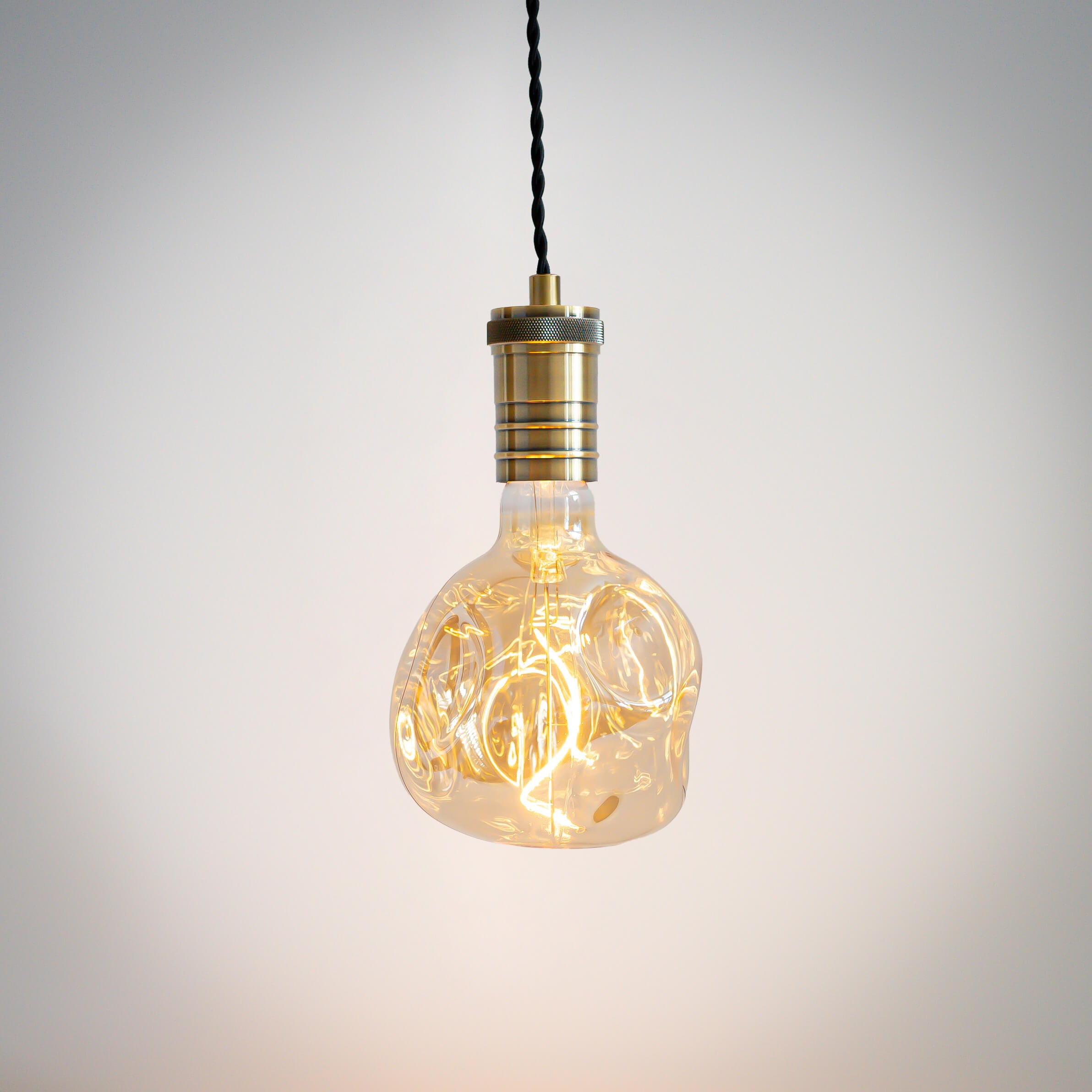 antique bronze pendant light with twisted cable and isabella bulb on