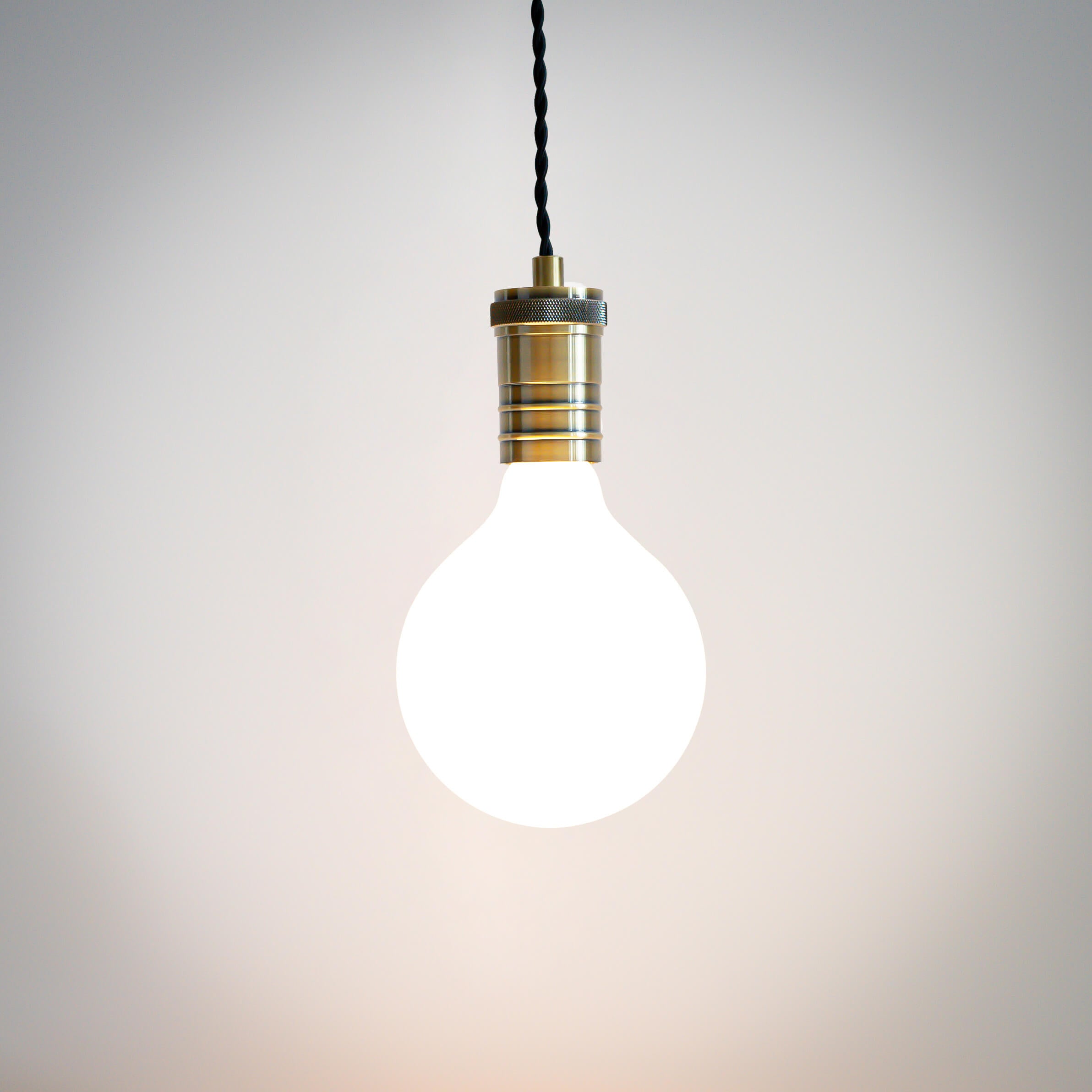 antique bronze pendant light with twisted cable and luna bulb on