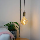 antique bronze plug in pendant light and straight cable isabella bulb in living room on