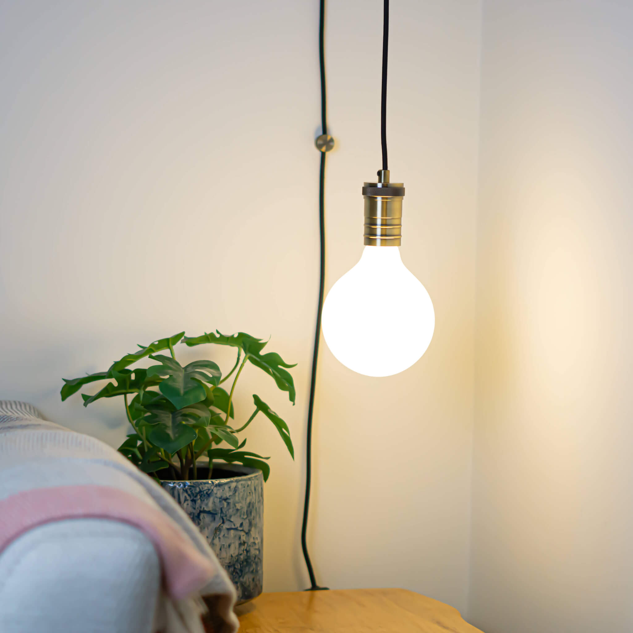 antique bronze plug in pendant light and straight cable luna bulb in living room on