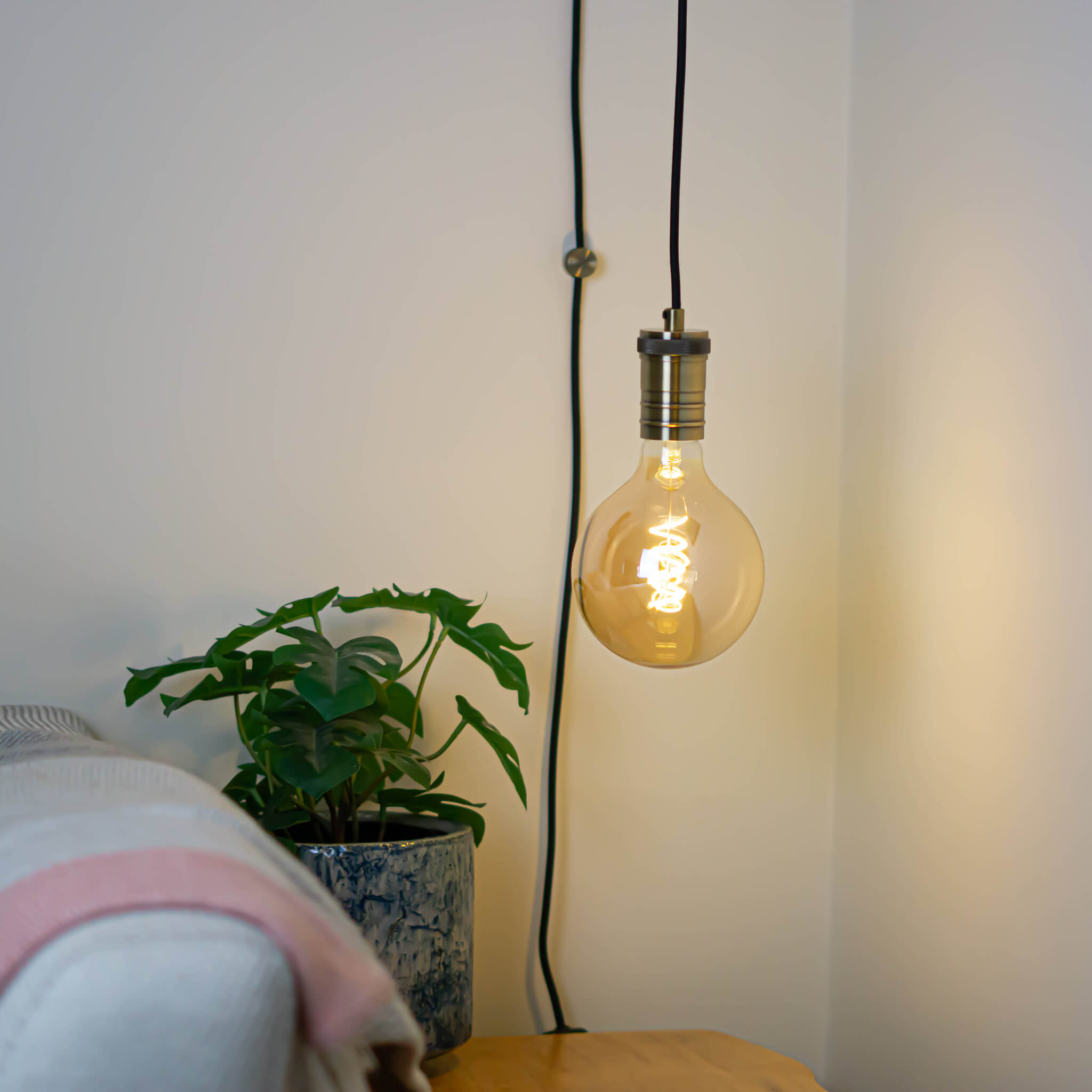 antique bronze plug in pendant light and straight cable sophia bulb in living room on