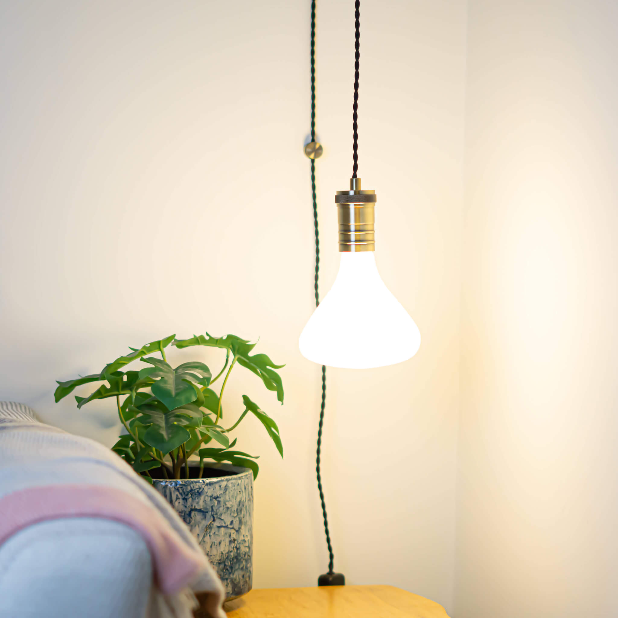 antique bronze plug in pendant light and twisted cable astrid bulb in living room on