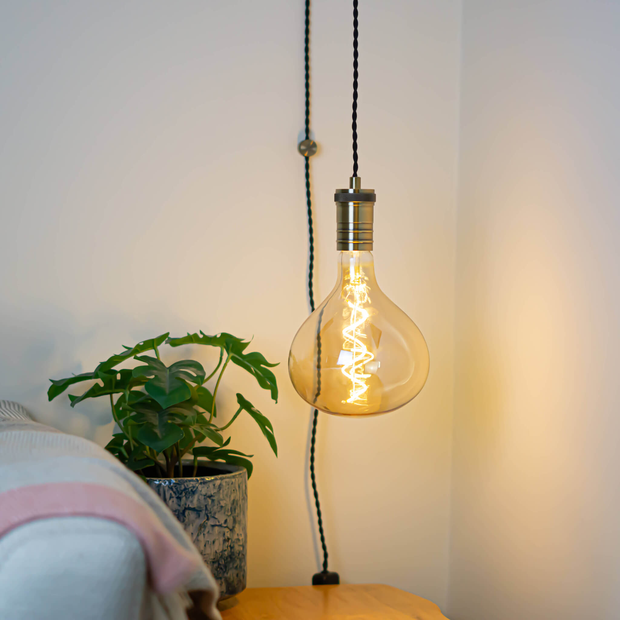 antique bronze plug in pendant light and twisted cable olivia bulb in living room on