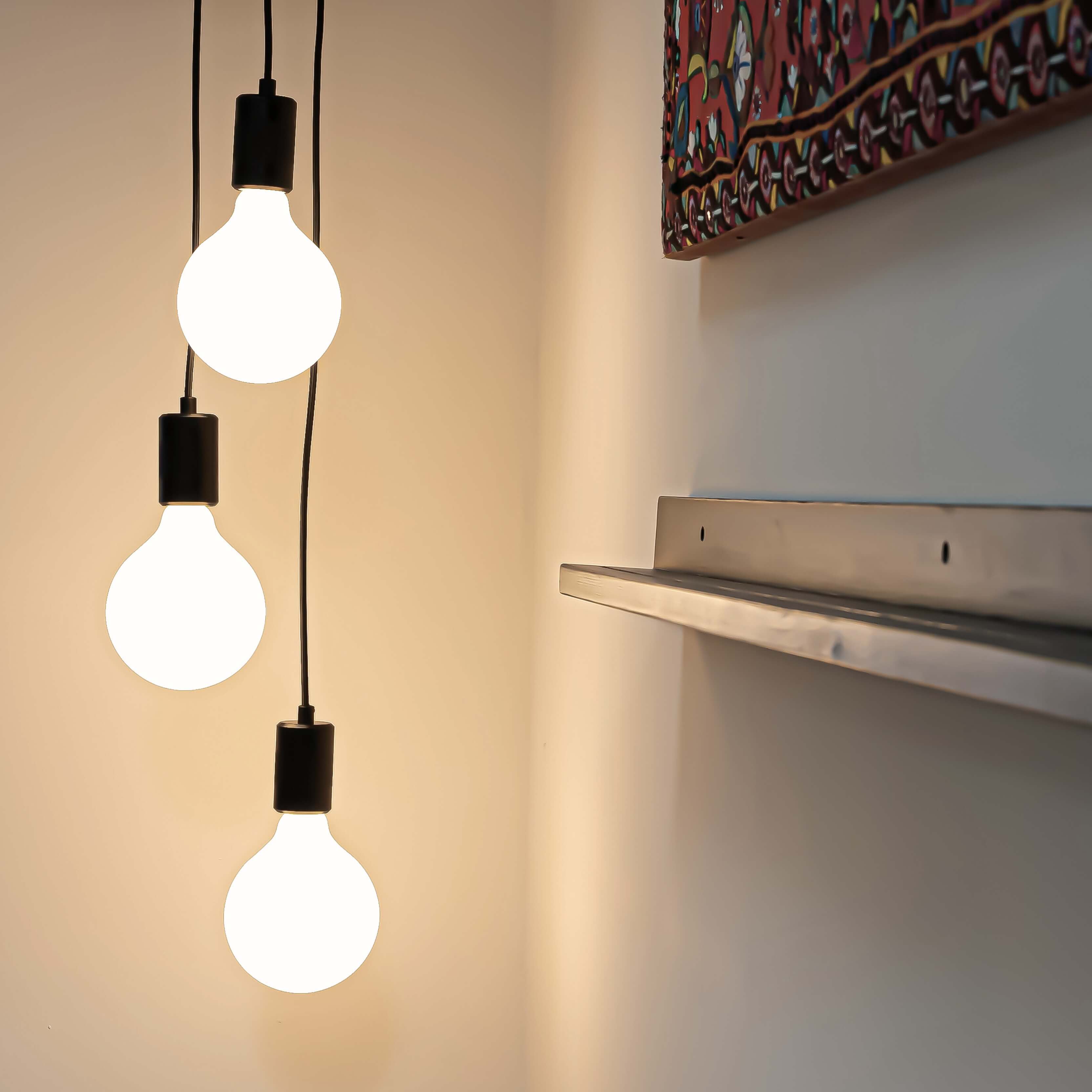 Black cluster pendant with luna bulbs in the living room side view