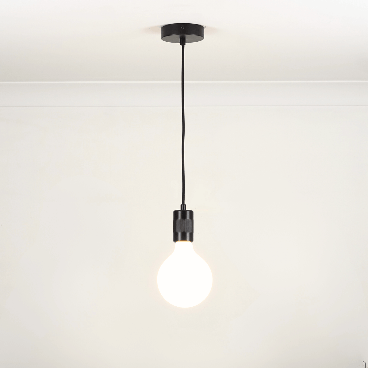 Black single pendant white background with luna bulb