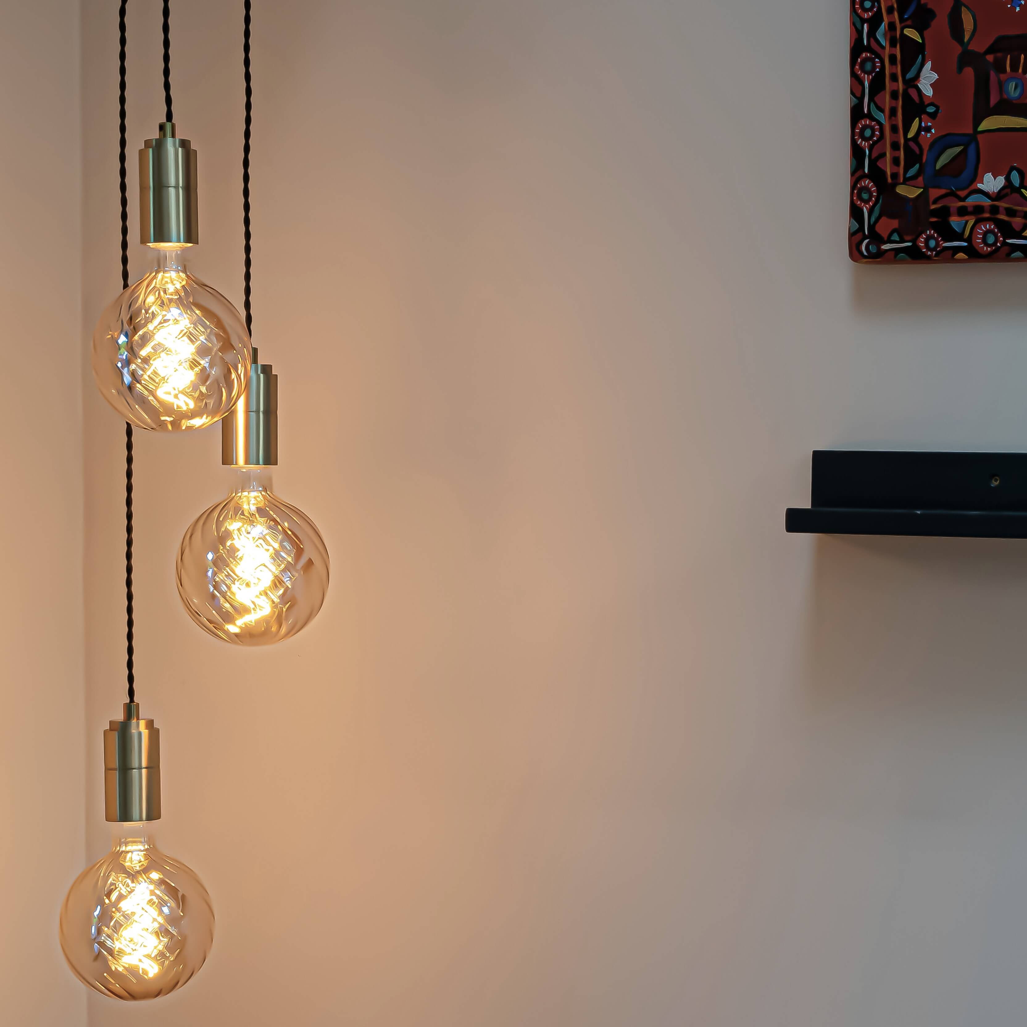 Brass cluster pendant with twisted cable and felicity bulbs in the living room