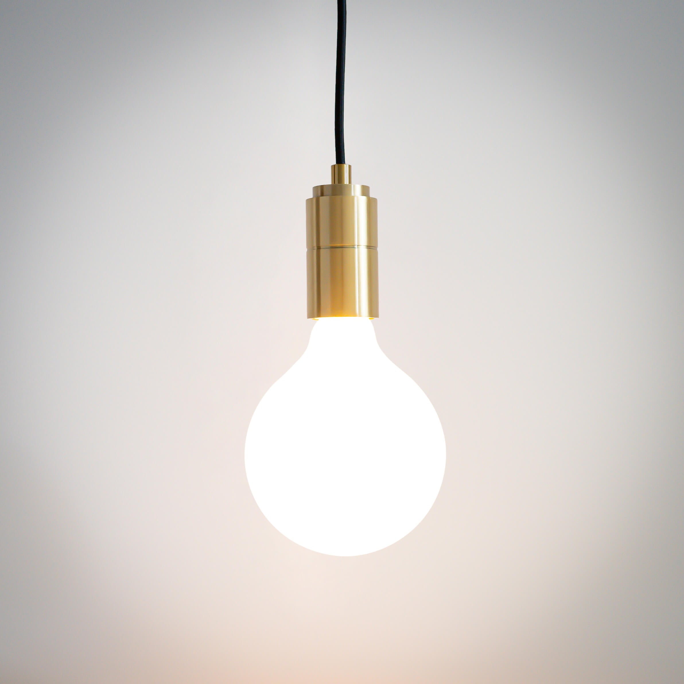 brass pendant light with straight cable and luna bulb on