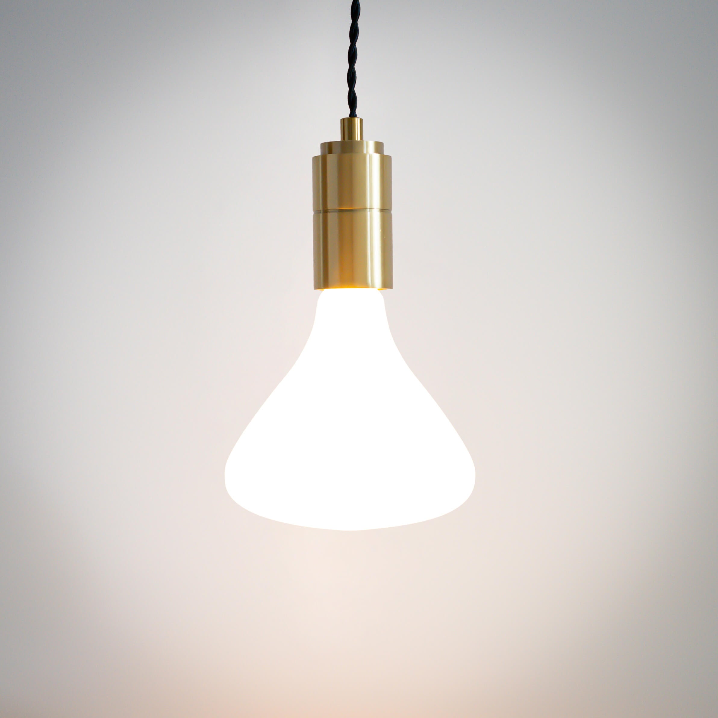 brass pendant light with twisted cable and astrid bulb on
