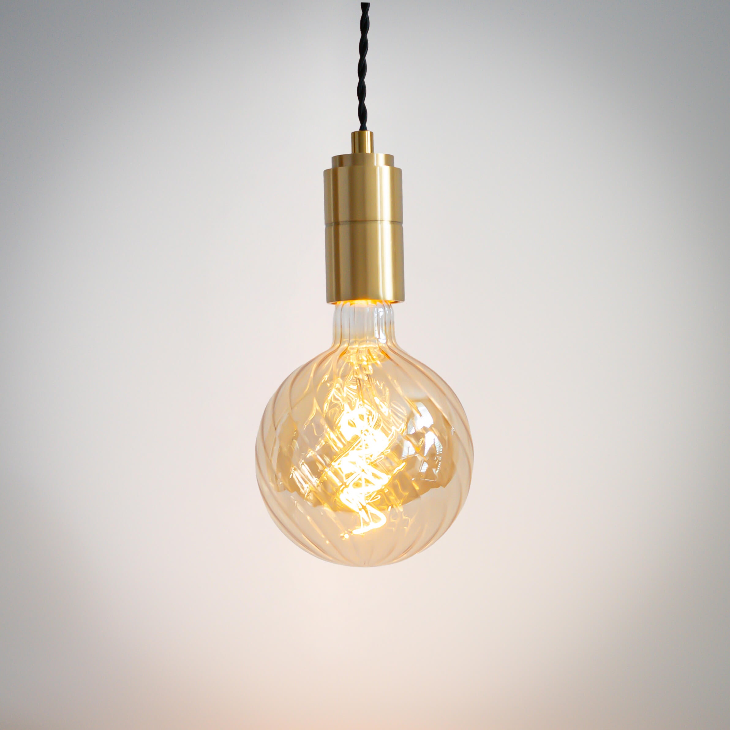 brass pendant light with twisted cable and felicity bulb on