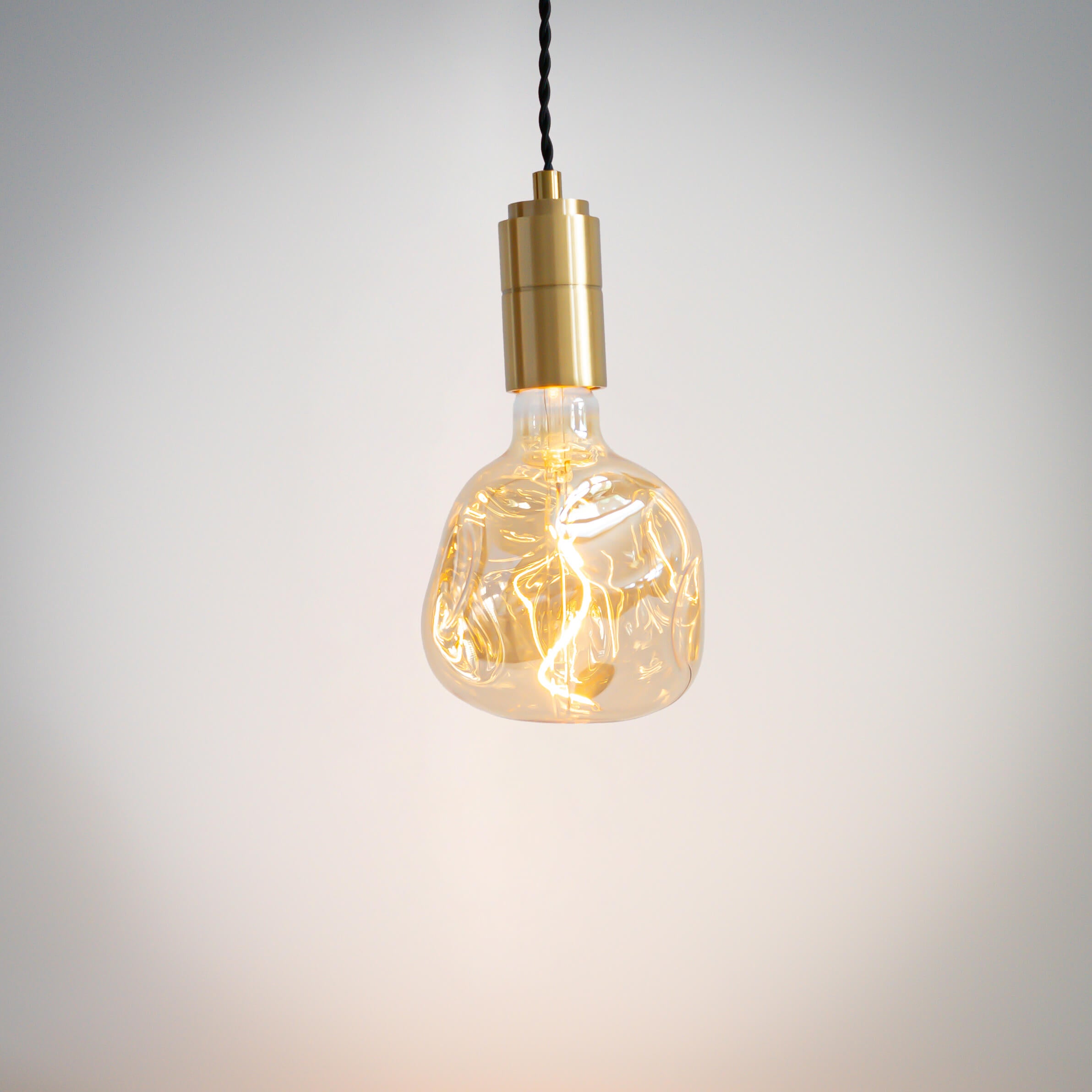 brass pendant light with twisted cable and isabella bulb on