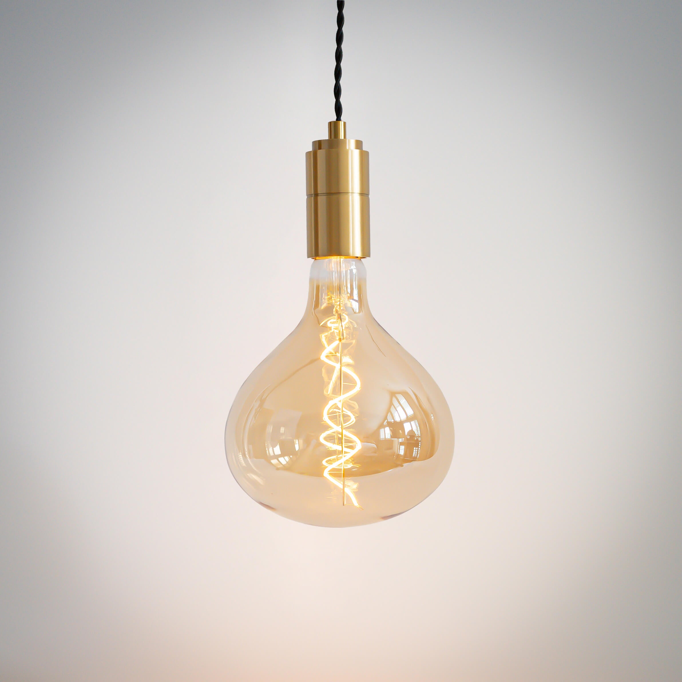 brass pendant light with twisted cable and olivia bulb on