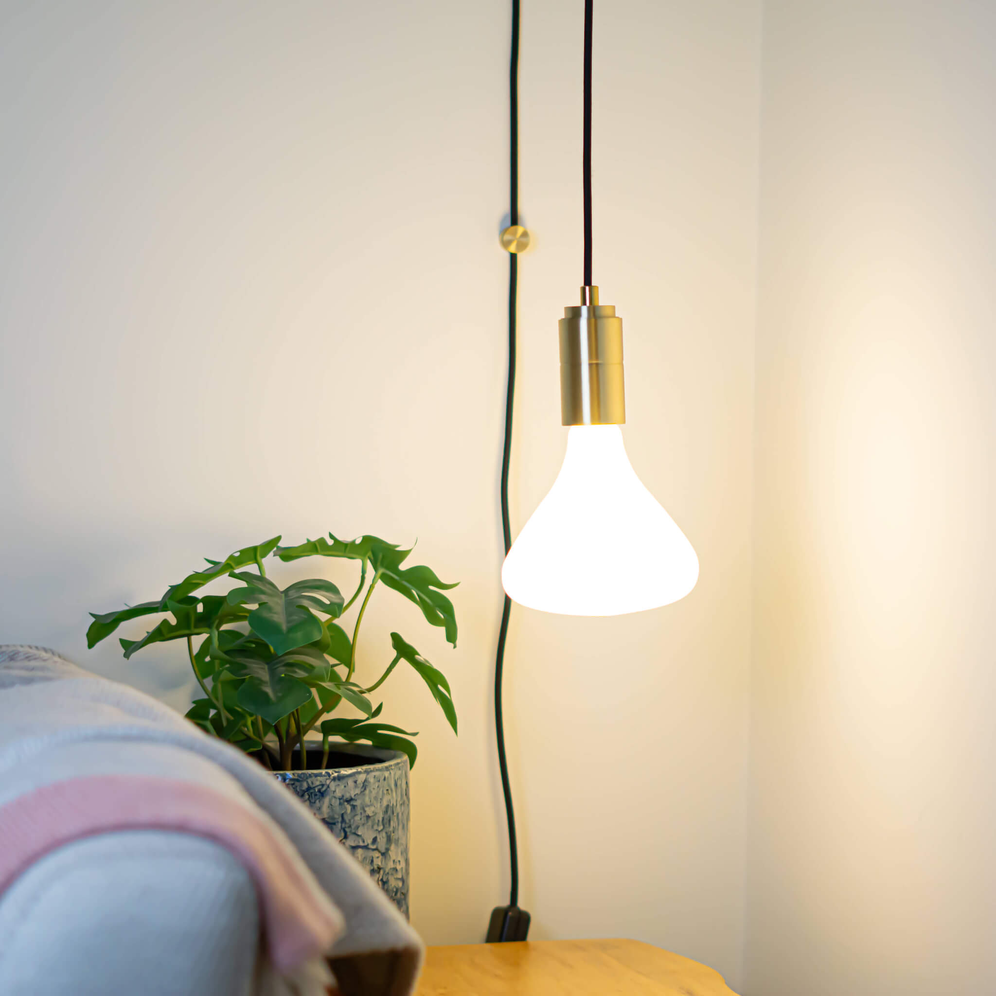 brass plug in pendant light and straight cable astrid bulb in living room on