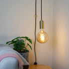 brass plug in pendant light and straight cable felicity bulb in living room on