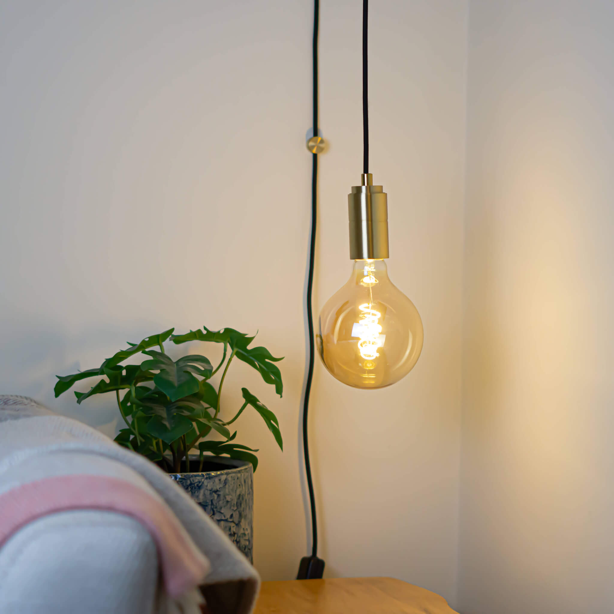 brass plug in pendant light and straight cable sophia bulb in living room on