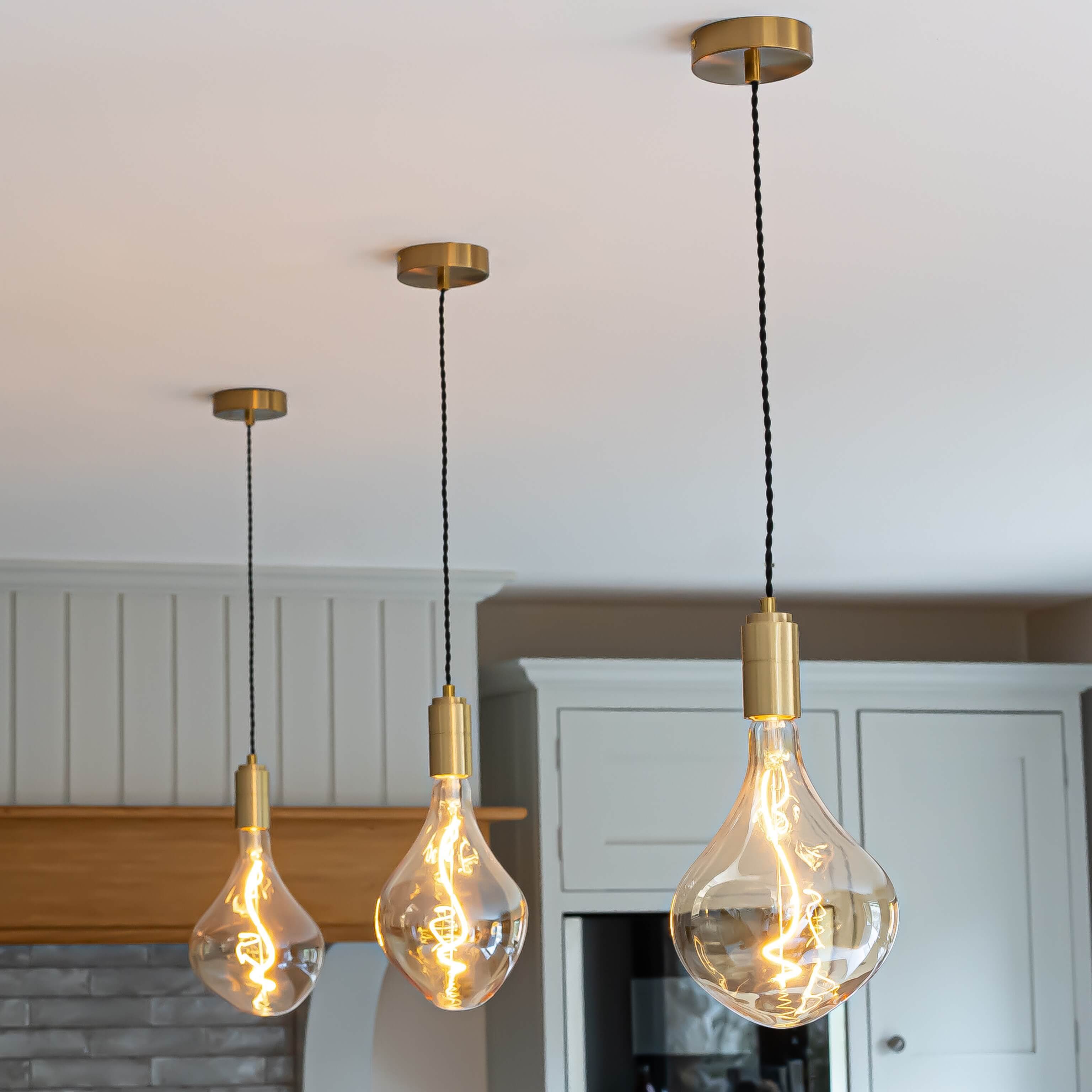 celeste brass pendant light above kitchen island