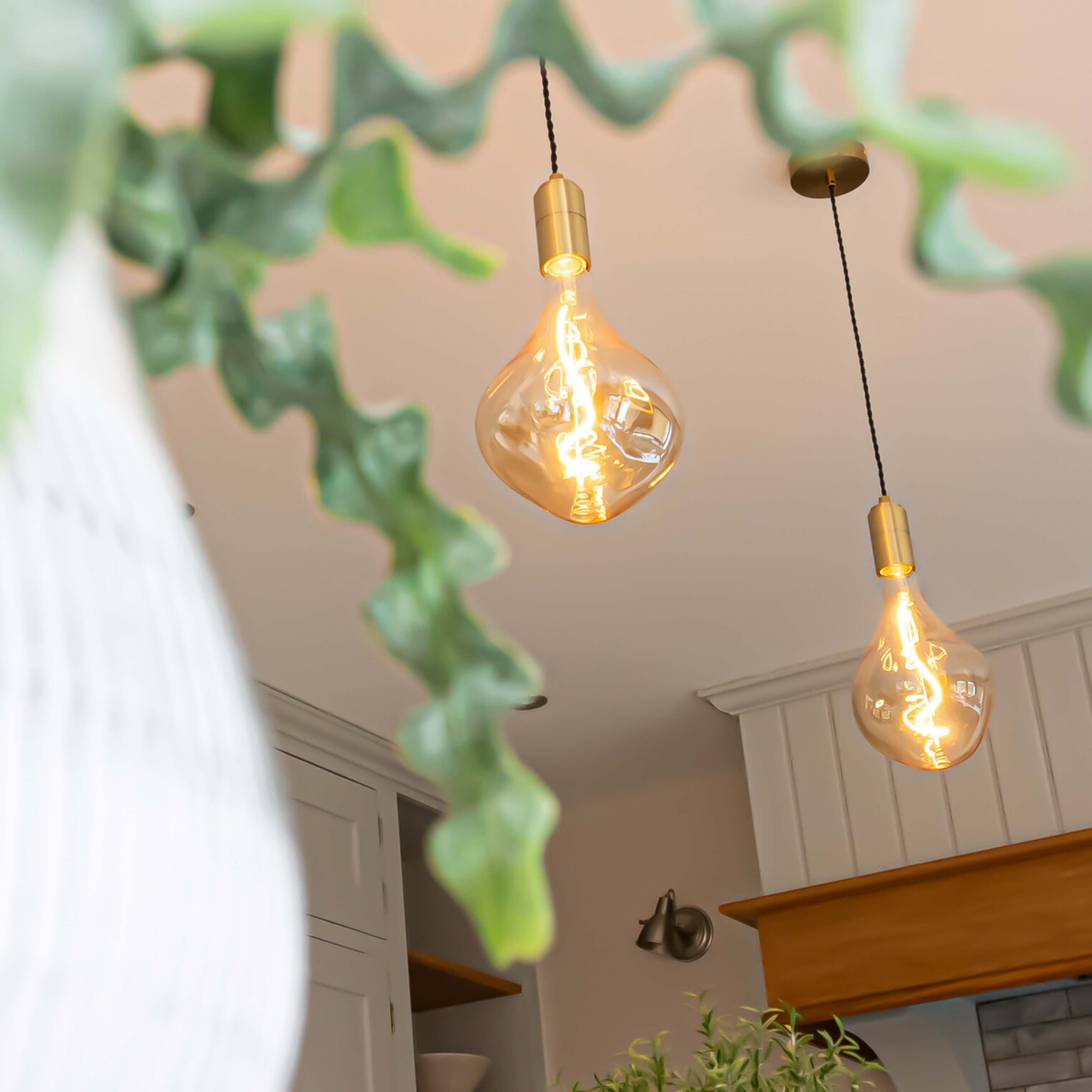 celeste brass pendant light hanging over a kitchen island