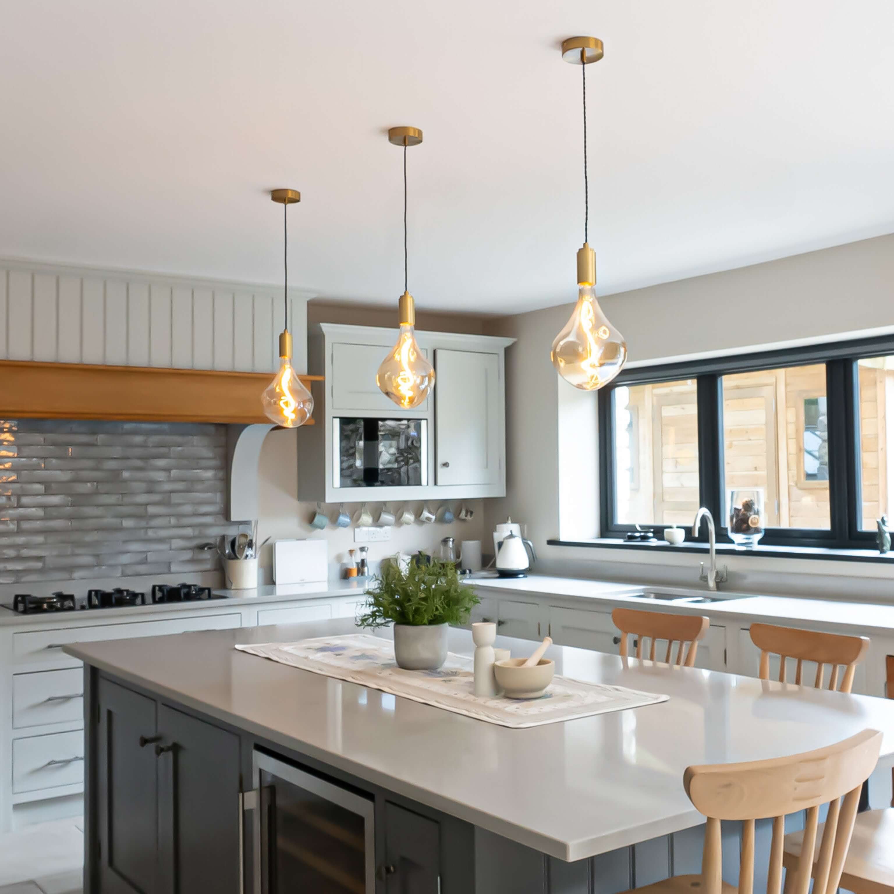 celeste brass pendant light wide angle view over a kitchen island
