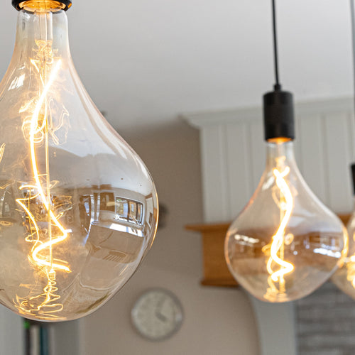 celeste matte black pendant light  reflection suspended above the kitchen island