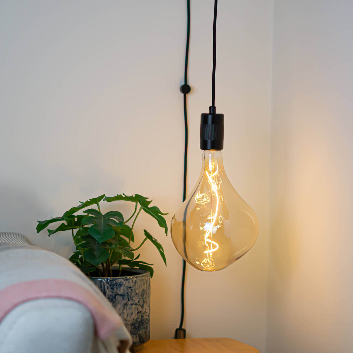 matte black plug in pendant light with celeste bulb in living room on
