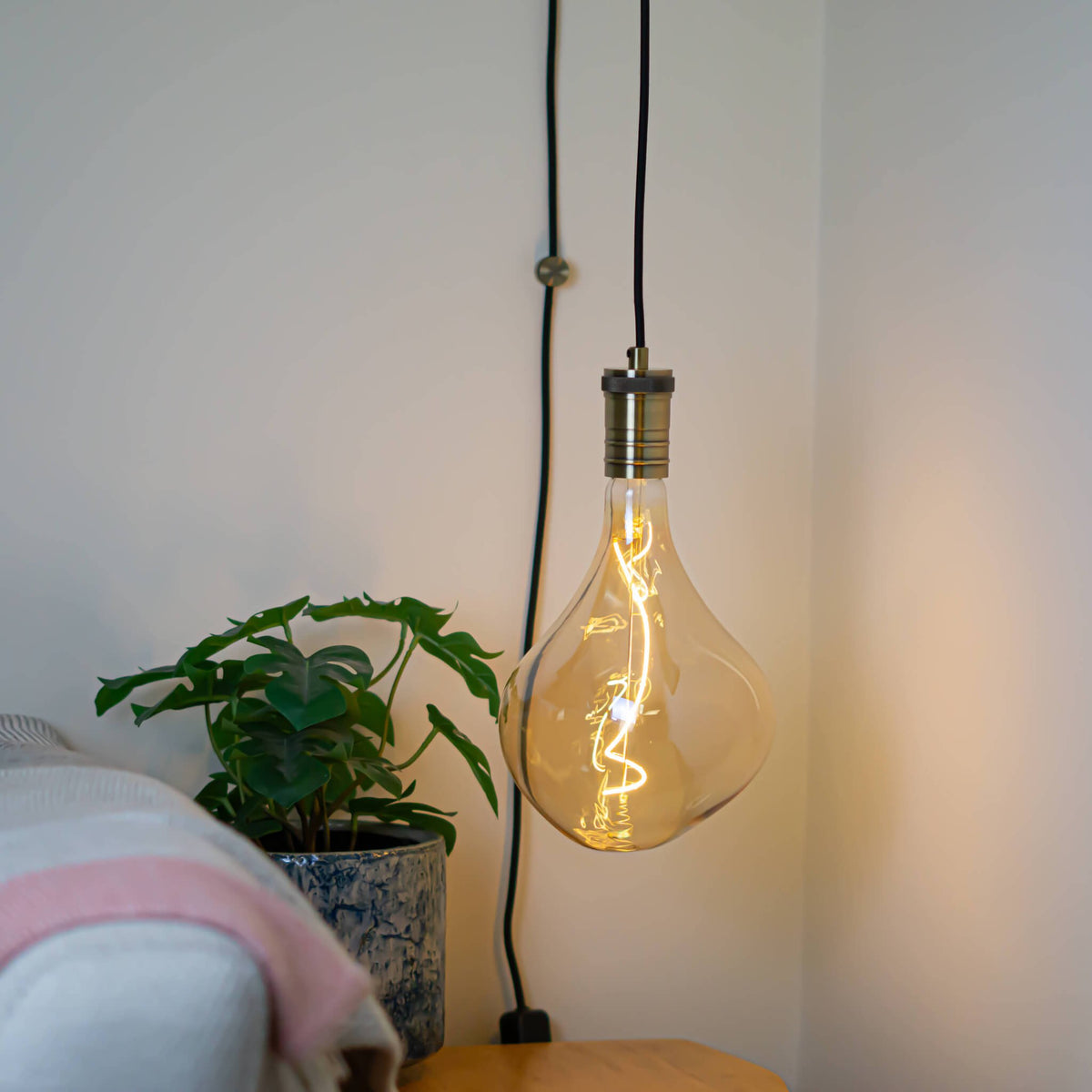 antique bronze plug in pendant light and straight cable with celeste bulb in living room on