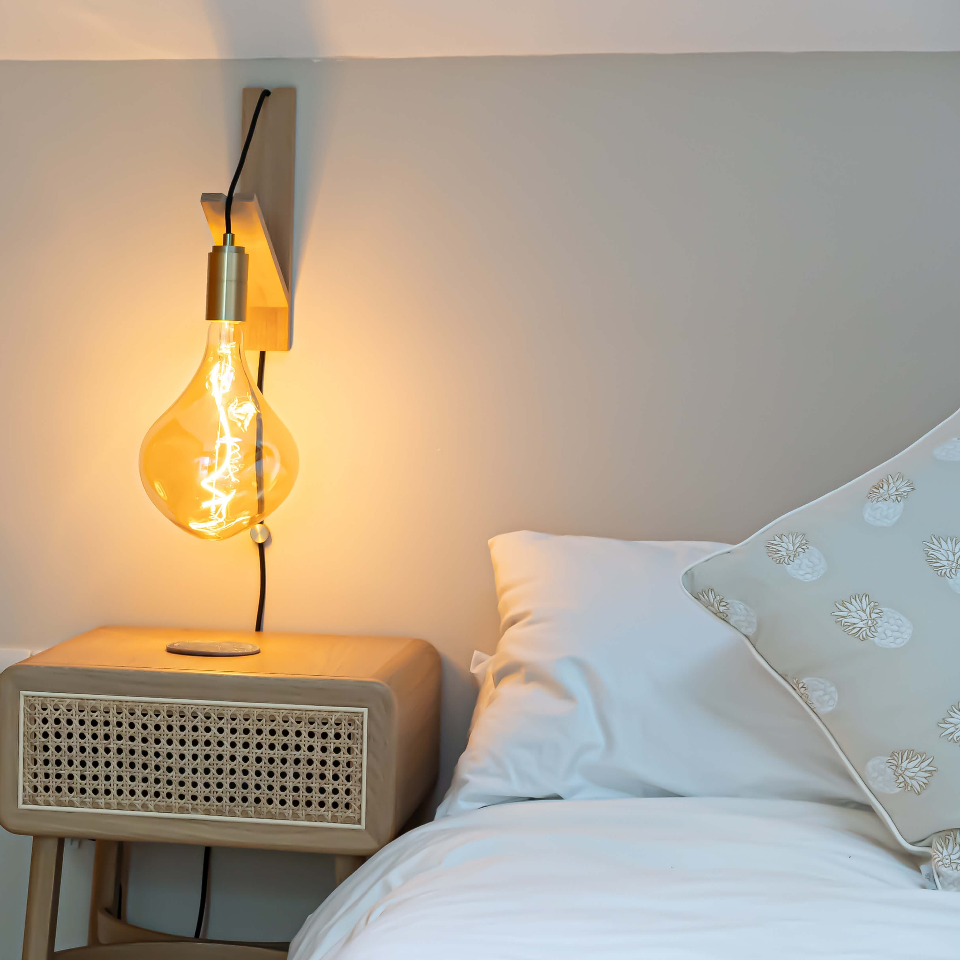 celeste plug in wall light in brass in the bedroom