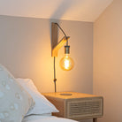 felicity plug in antique brass wall light with twisted cable mounted by a bed