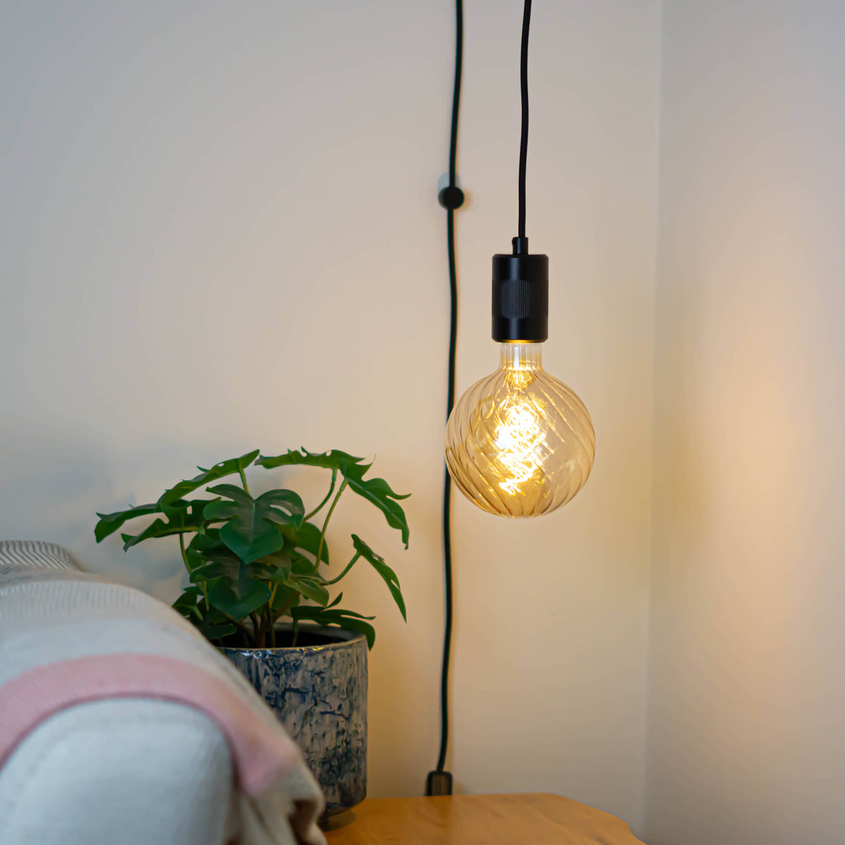 matte black plug in pendant light felicity bulb in living room on