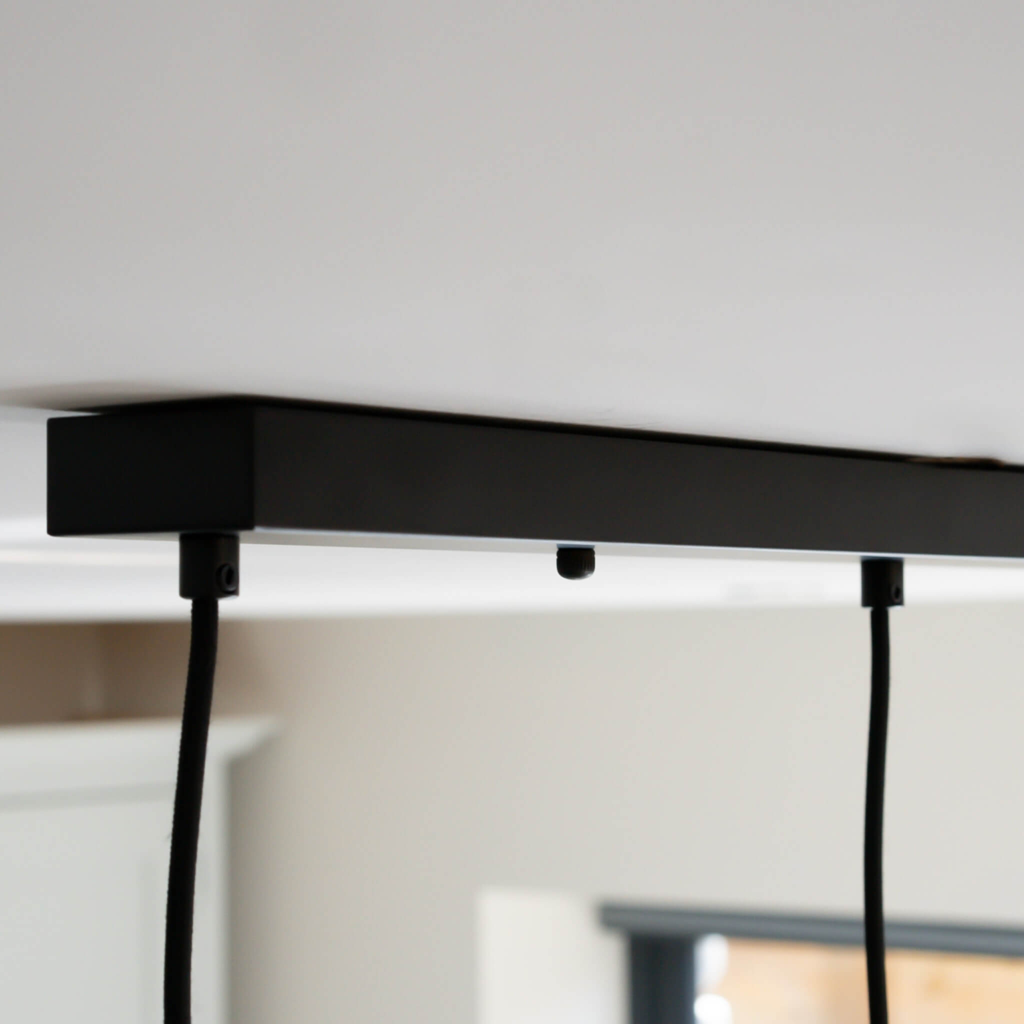 matte black ceiling rose with straight cable closeup