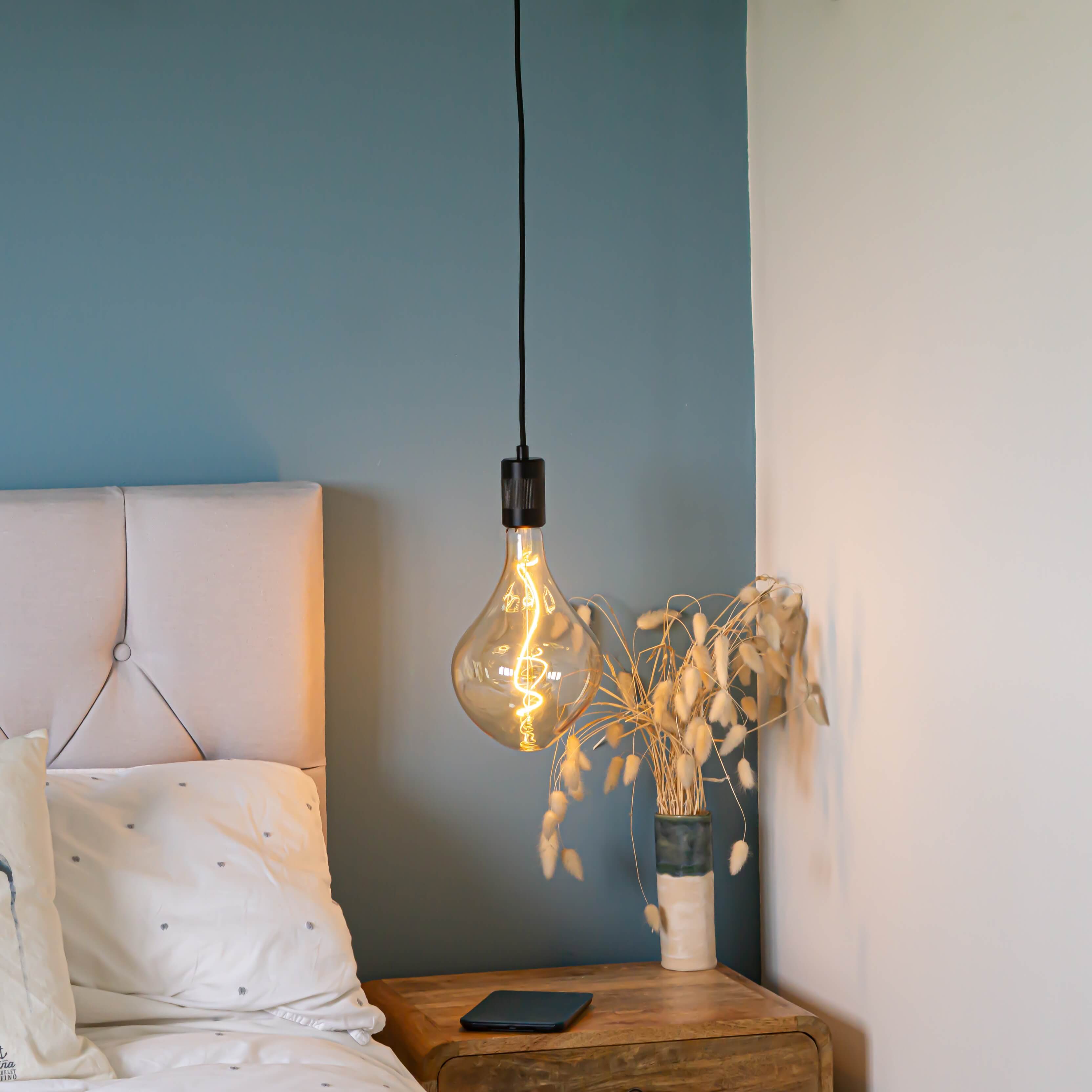 matte black pendant light with celeste bulb hanging above the bedside table in the bedroom AM3308-CEL-BLA-ST