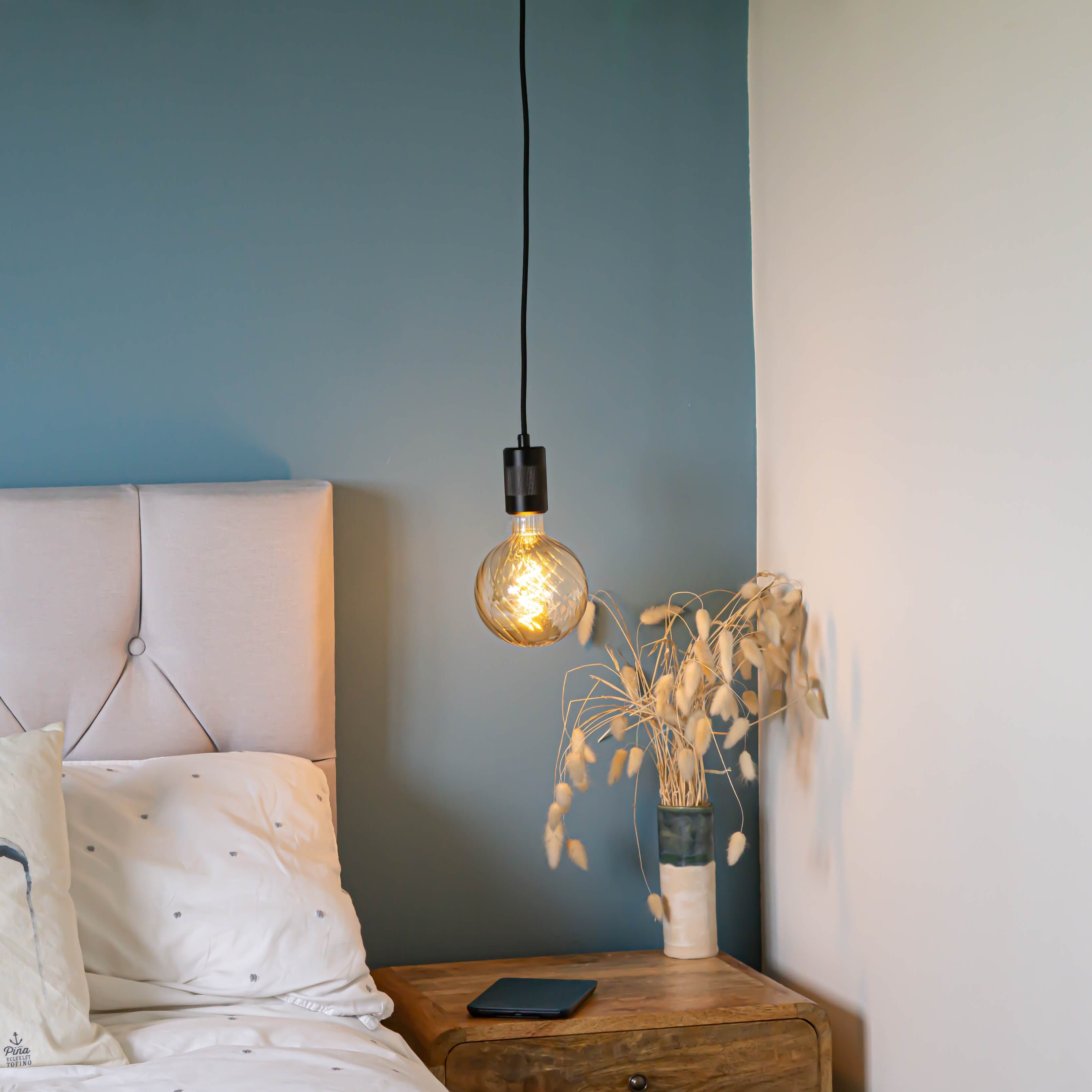 matte black pendant light with felicity bulb hanging above the bedside table