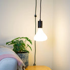 matte black plug in pendant light astrid bulb in living room on