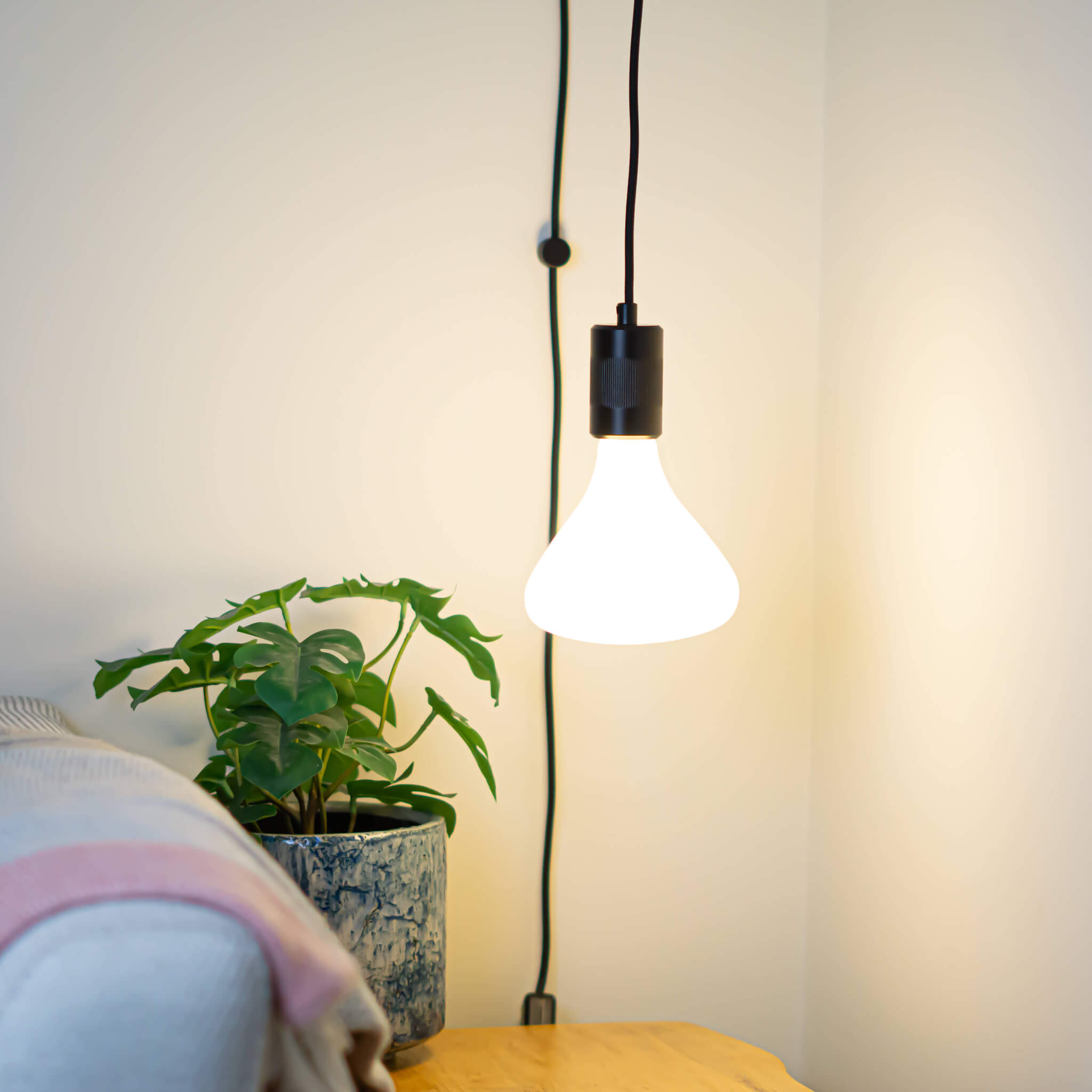 matte black plug in pendant light astrid bulb in living room on