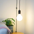 matte black plug in pendant light luna bulb in living room on