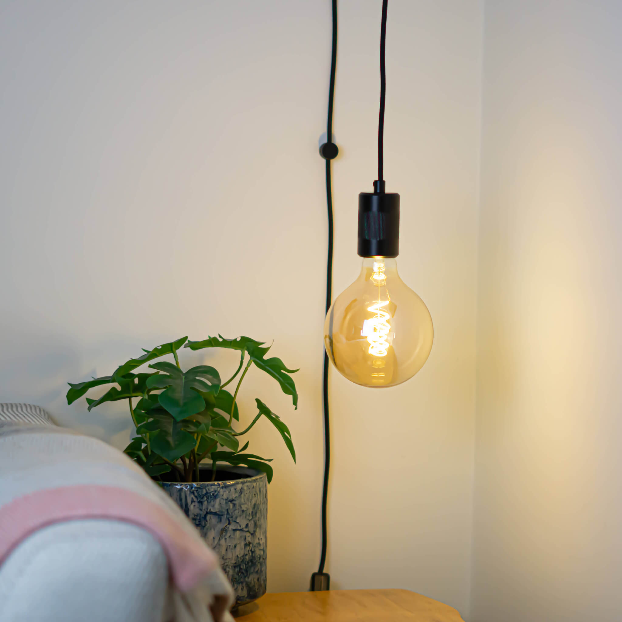 matte black plug in pendant light sophia bulb in living room on