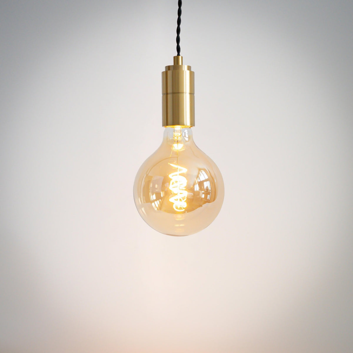 brass pendant light with twisted cable and sophia bulb on