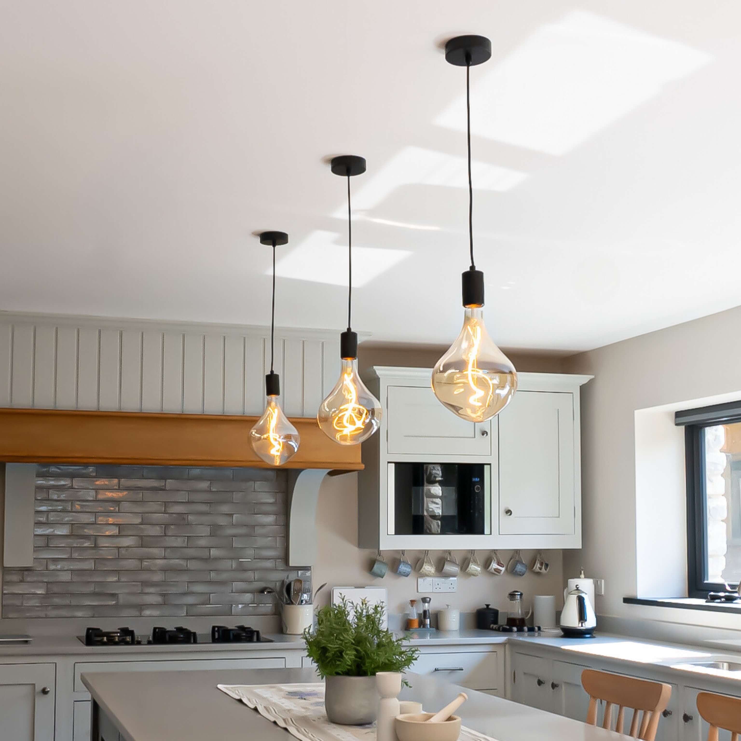 Exposed bulb pendants over a country style kitchen
