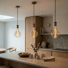 Antique brass twisted pendant over kitchen island