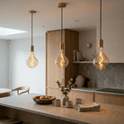 Modern kitchen with pendant lights hanging above a countertop.