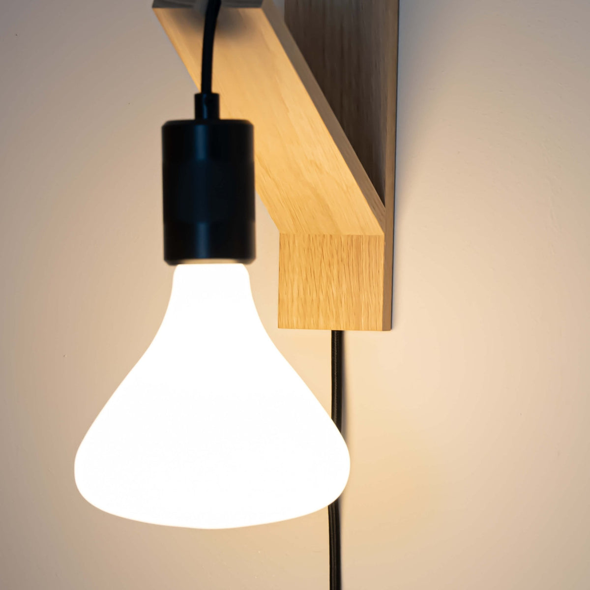 black plug in wall light in matte black  