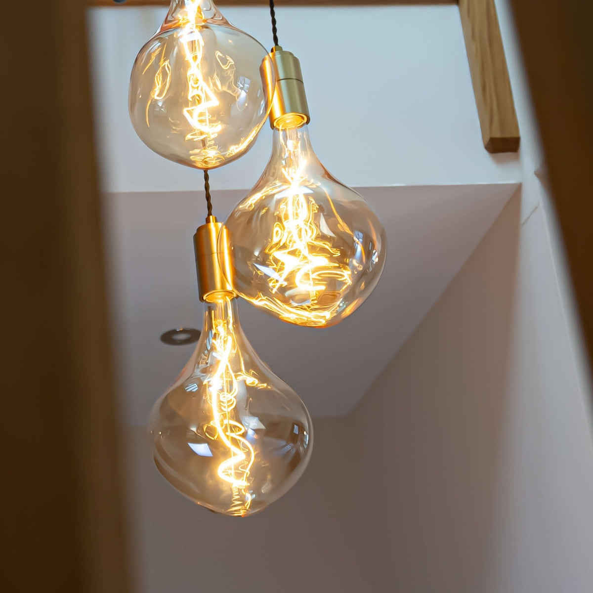 Brass cluster pendant with twisted cable and Celeste bulbs hallway