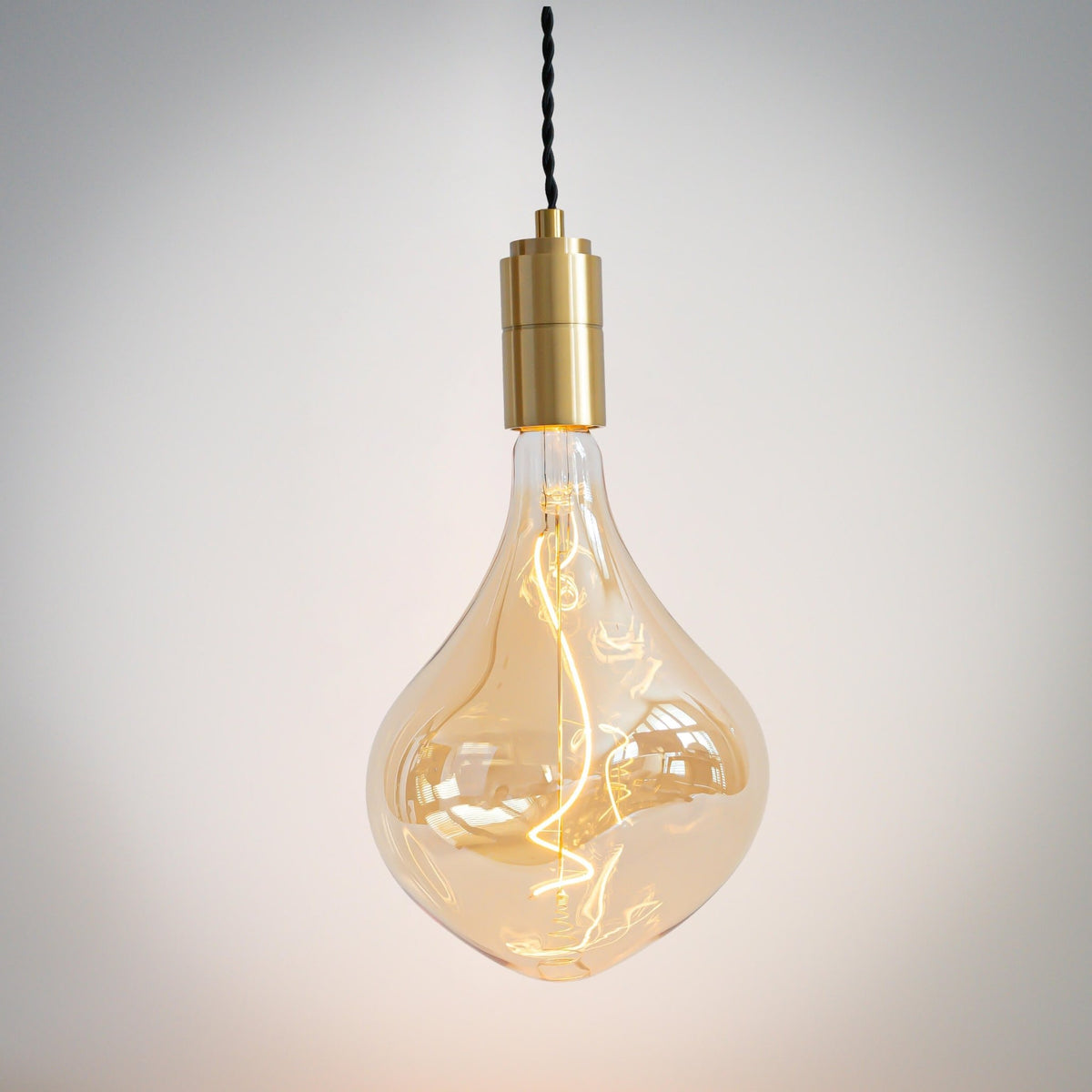 brass pendant light with twisted cable and céleste bulb on