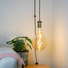 antique bronze plug in pendant light and twisted cable with celeste bulb in living room on