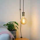 antique bronze plug in pendant light and twisted cable felicity bulb in living room on