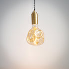 brass pendant light with twisted cable and isabella bulb on