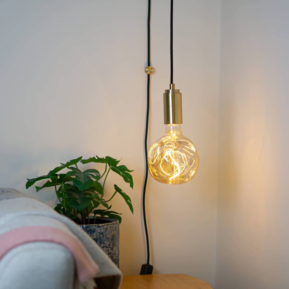 brass plug in pendant light and straight cable isabella bulb in living room on