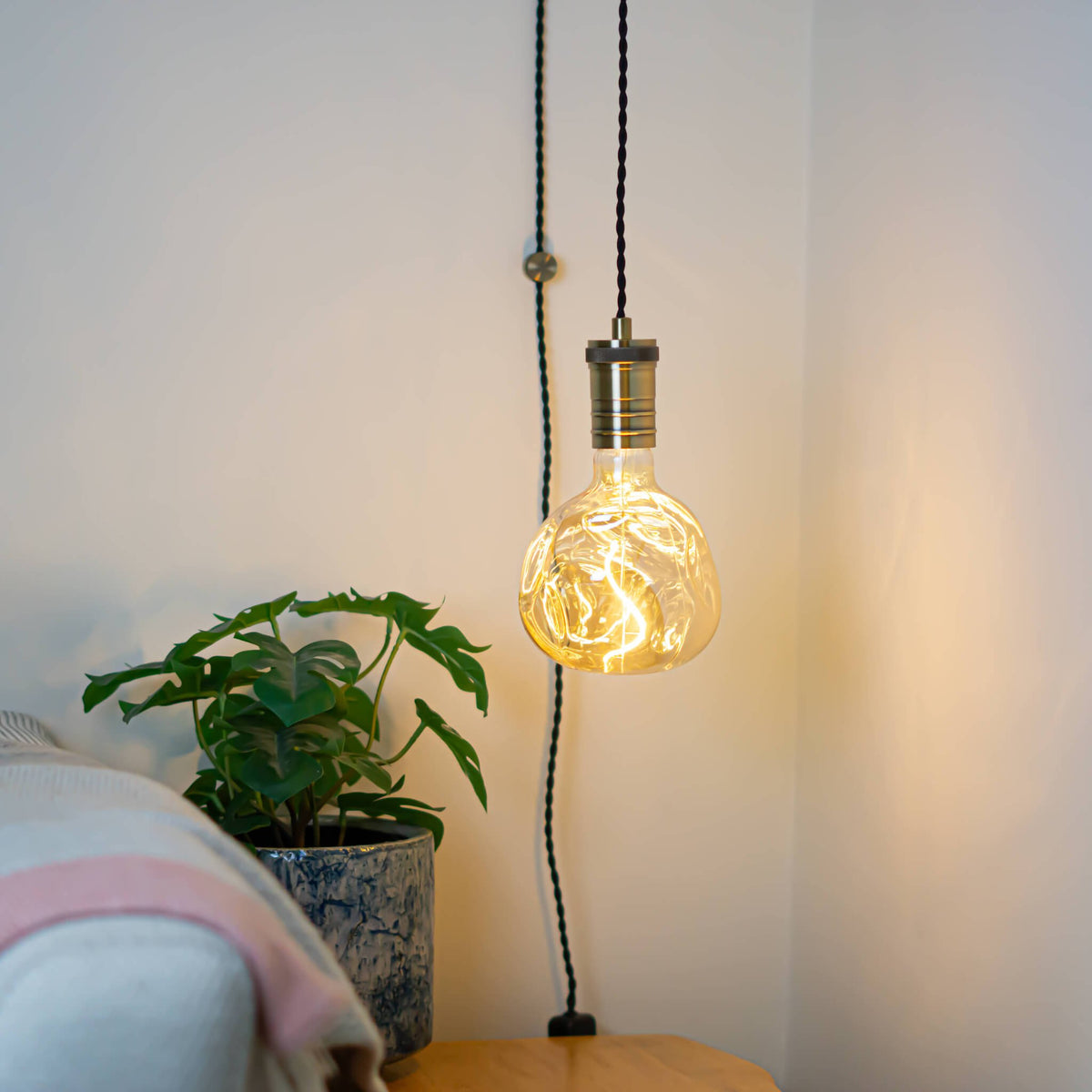 antique bronze plug in pendant light and twisted cable isabella bulb in living room on