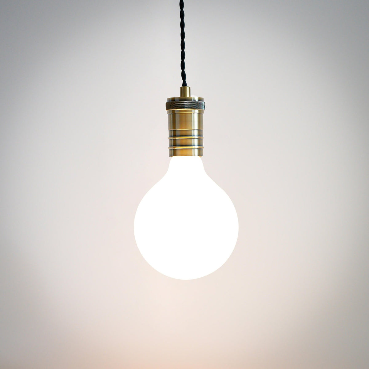 antique bronze pendant light with twisted cable and luna bulb on